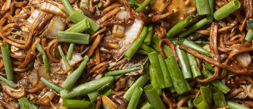 Closeup shot of noodles with scallions and crab